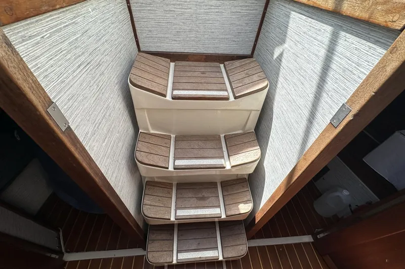 Slide: The Image of Wooden steps inside a 1991 Catalina 42 sailboat, featuring a compact and stylish design. - 25