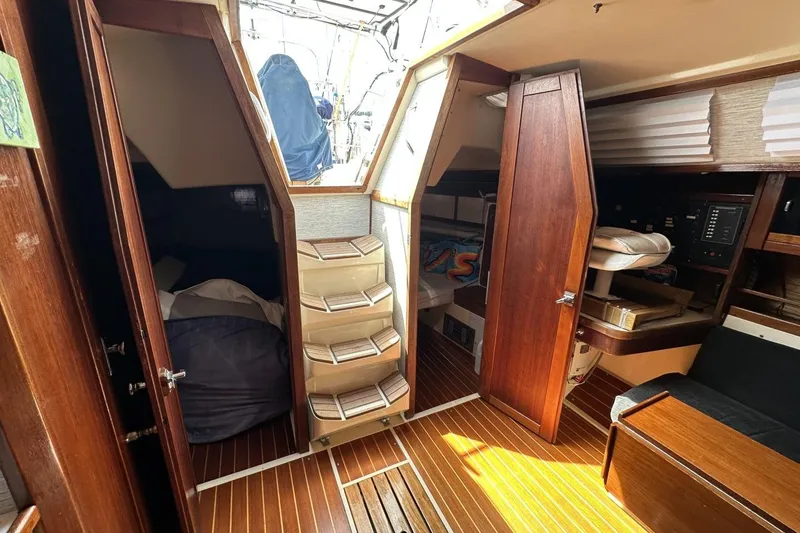 Slide: The Image of Interior of a 1991 Catalina 42 sailboat with wooden finishes and cozy cabins. - 26