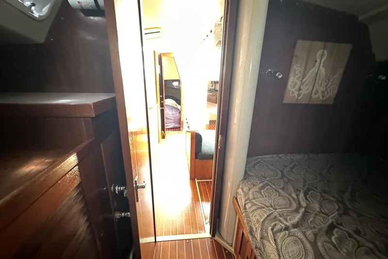 Slide: The Image of Interior of a 1991 Catalina 42 sailboat with wooden finishes and cozy cabin. - 28
