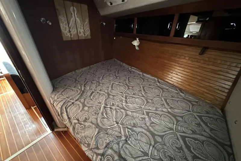 Slide: The Image of Cozy cabin interior of 1991 Catalina 42 sailboat with patterned bedding and wooden accents. - 29