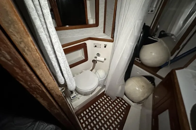 Slide: The Image of Bathroom interior of a 1991 Catalina 42 sailboat with nautical equipment. - 35