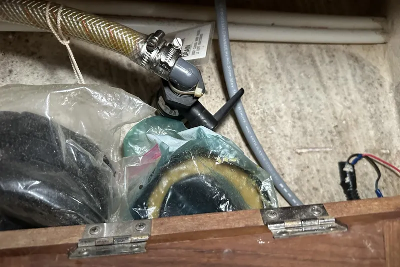 Slide: The Image of Boat plumbing components in a Catalina 42, 1991 model, with hoses and fittings. - 38