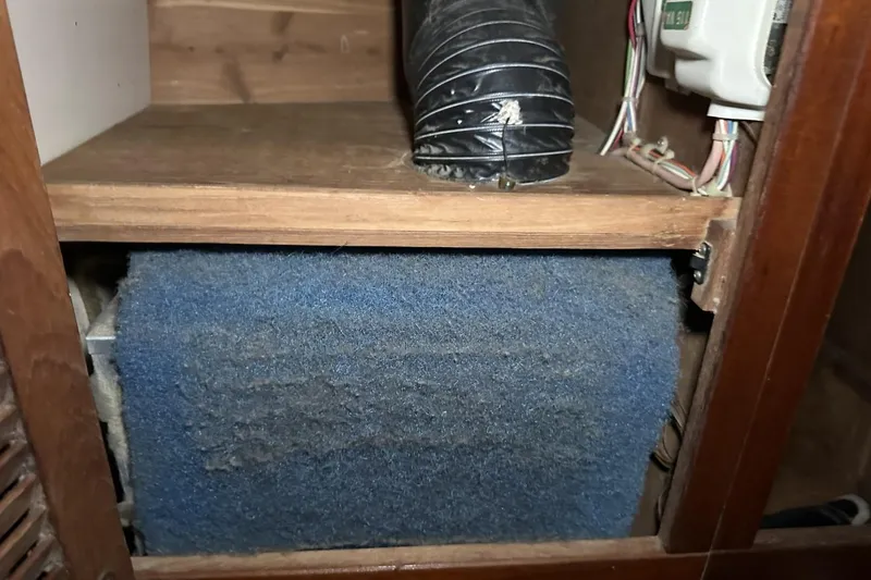 Slide: The Image of Dusty air filter and duct inside a 1991 Catalina 42 boat compartment. - 41