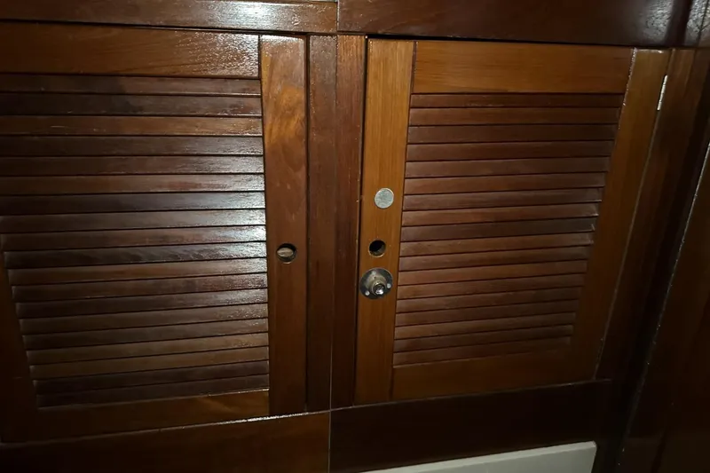 Slide: The Image of Wooden cabinet doors inside a 1991 Catalina 42 sailboat. - 44