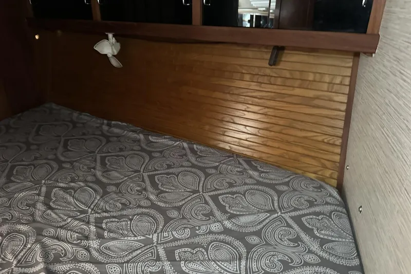 Slide: The Image of Cozy cabin interior of a 1991 Catalina 42 sailboat with patterned bedding. - 46