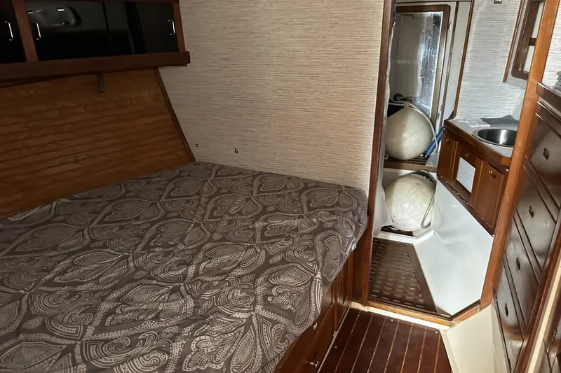 Slide: The Image of Interior of a 1991 Catalina 42 sailboat with a cozy cabin and wooden furnishings. - 47