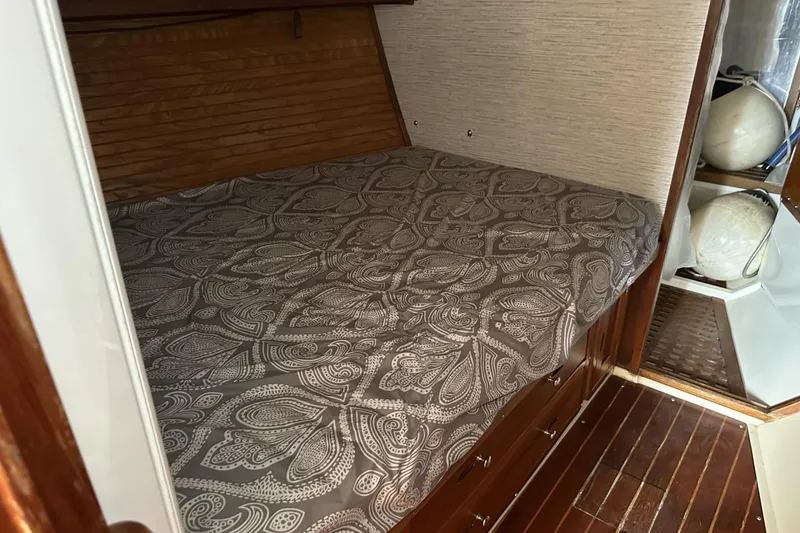 Slide: The Image of Cozy cabin interior of a 1991 Catalina 42 sailboat with patterned bedding. - 49