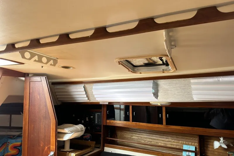 Slide: The Image of Interior of a 1991 Catalina 42 sailboat with wood paneling and storage compartments. - 50