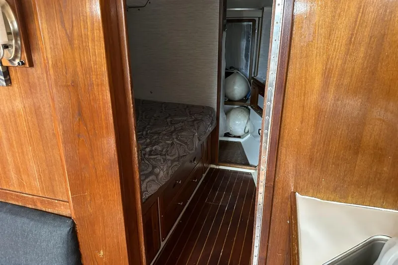 Slide: The Image of Interior of a 1991 Catalina 42 sailboat with wooden paneling and cozy cabin. - 51