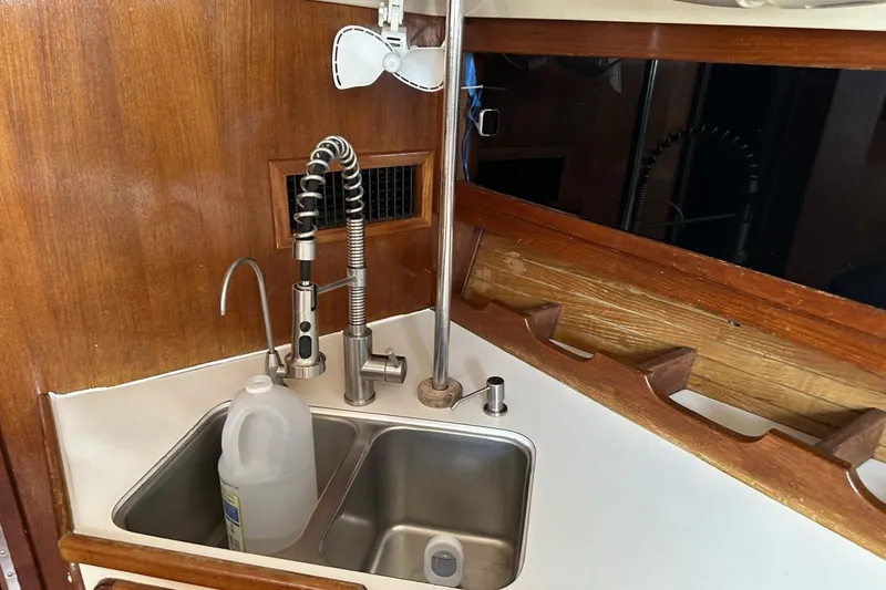 Slide: The Image of Galley sink area in a 1991 Catalina 42 sailboat with modern faucet. - 52