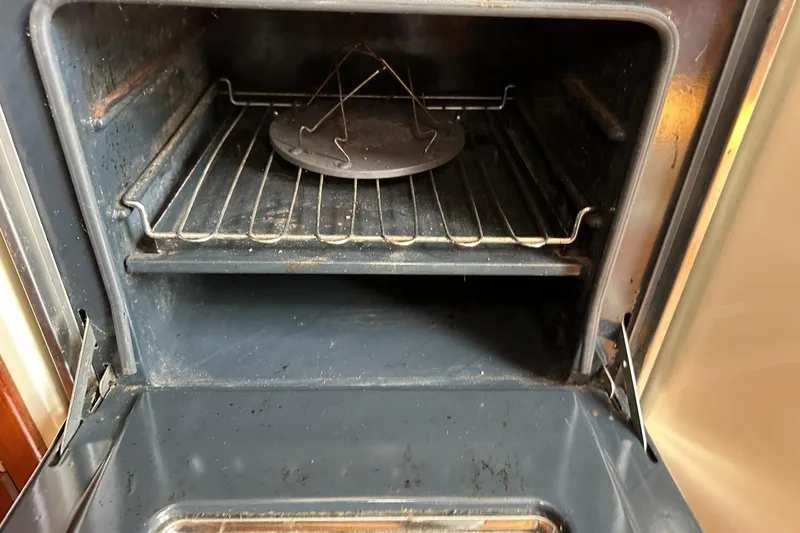 Slide: The Image of Open oven with metal rack inside a Catalina 42, 1991 model. - 54