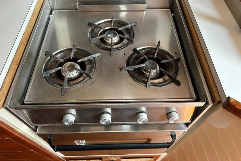 Slide: The Image of Stainless steel three-burner stove in a 1991 Catalina 42 yacht kitchen. - 55