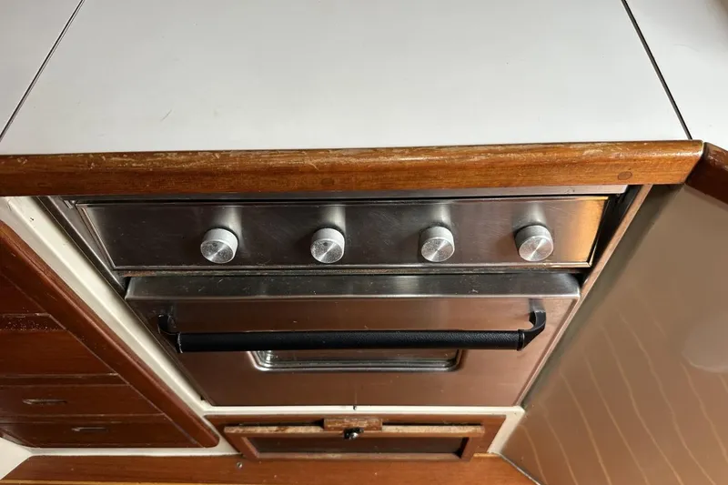 Slide: The Image of Stainless steel oven with knobs in a 1991 Catalina 42 yacht kitchen. - 56