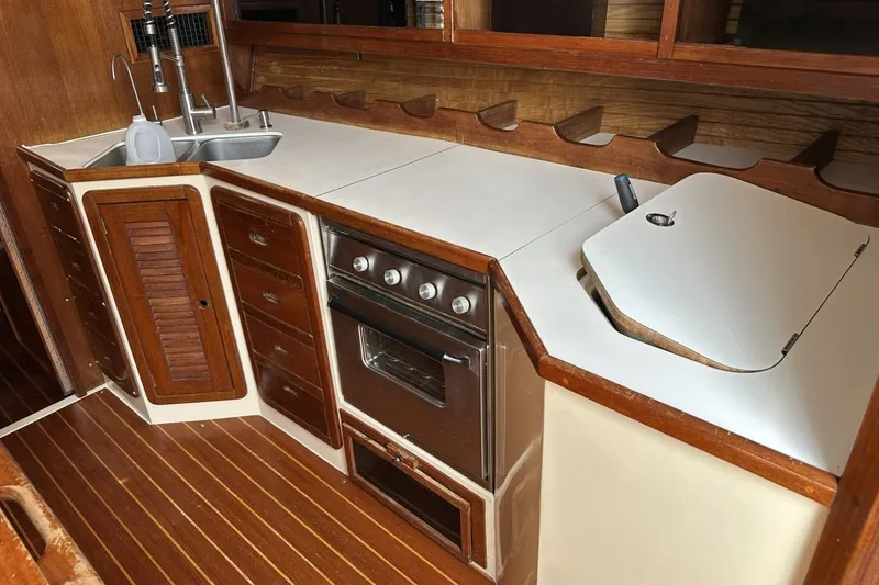Slide: The Image of Interior of 1991 Catalina 42 yacht kitchen with wooden cabinetry and stainless steel appliances. - 59