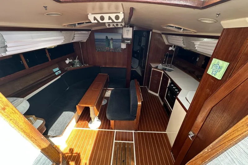 Slide: The Image of Interior of a 1991 Catalina 42 sailboat with wood finishes and cozy seating. - 6
