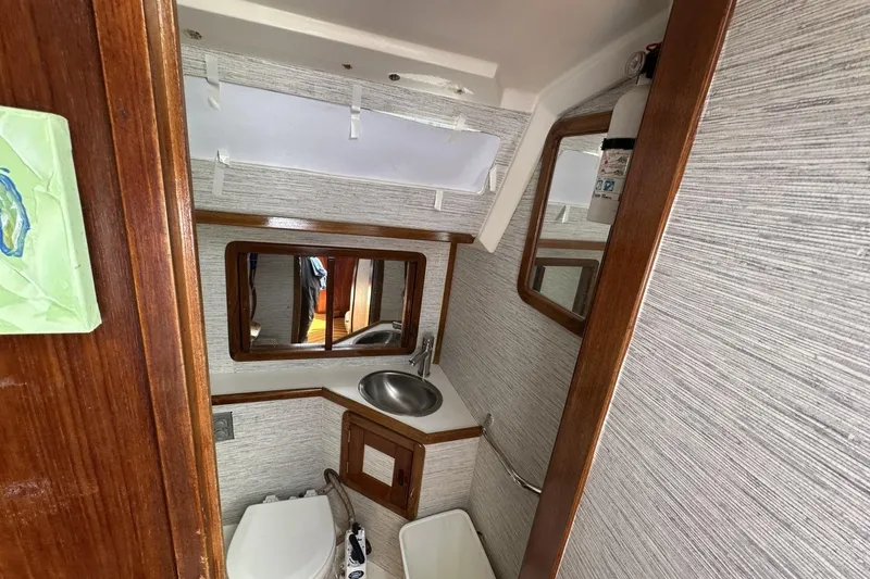 Slide: The Image of Bathroom interior of a 1991 Catalina 42 sailboat with sink and toilet. - 60