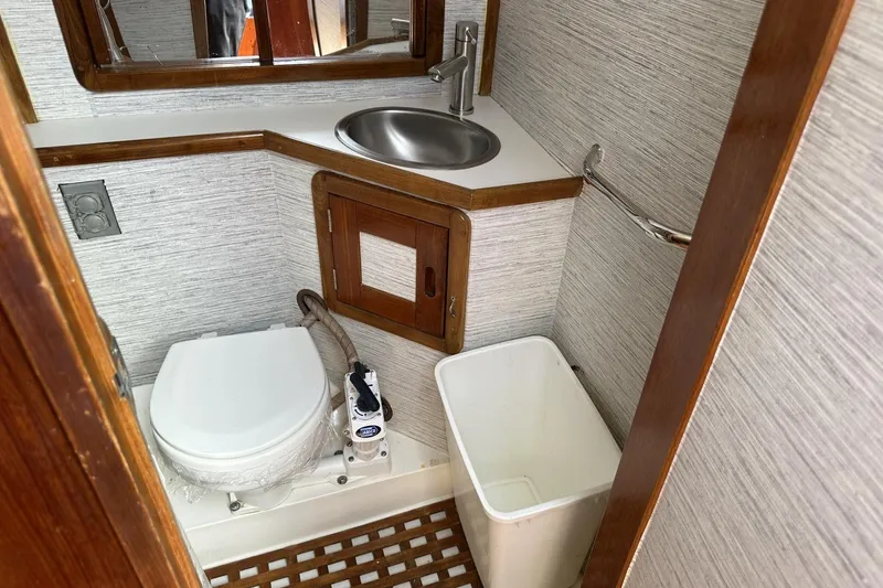 Slide: The Image of Bathroom interior of 1991 Catalina 42 yacht with toilet, sink, and waste bin. - 61