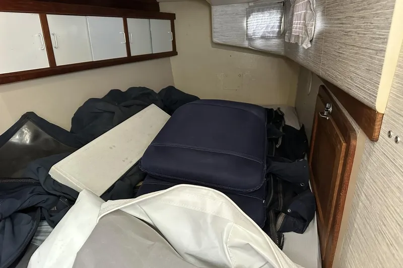 Slide: The Image of Interior cabin of a 1991 Catalina 42 sailboat with storage and cushions. - 64