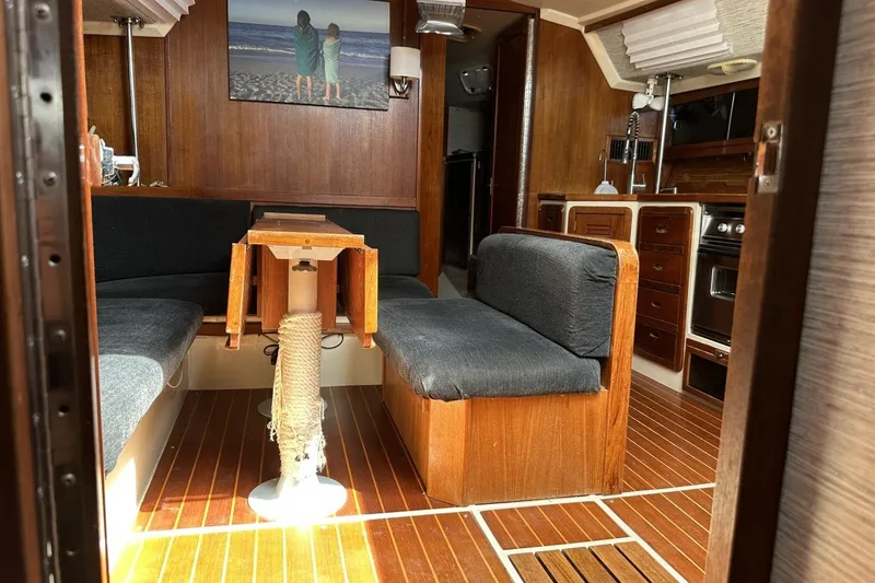 Slide: The Image of Interior of a 1991 Catalina 42 sailboat with wooden furnishings and cozy seating area. - 68