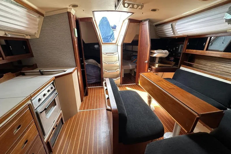 Slide: The Image of Interior of a 1991 Catalina 42 sailboat with wood finishes and seating area. - 7