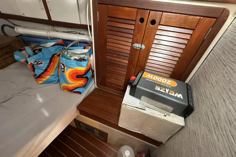 Slide: The Image of Interior of 1991 Catalina 42 sailboat with storage bags and inverter. - 73