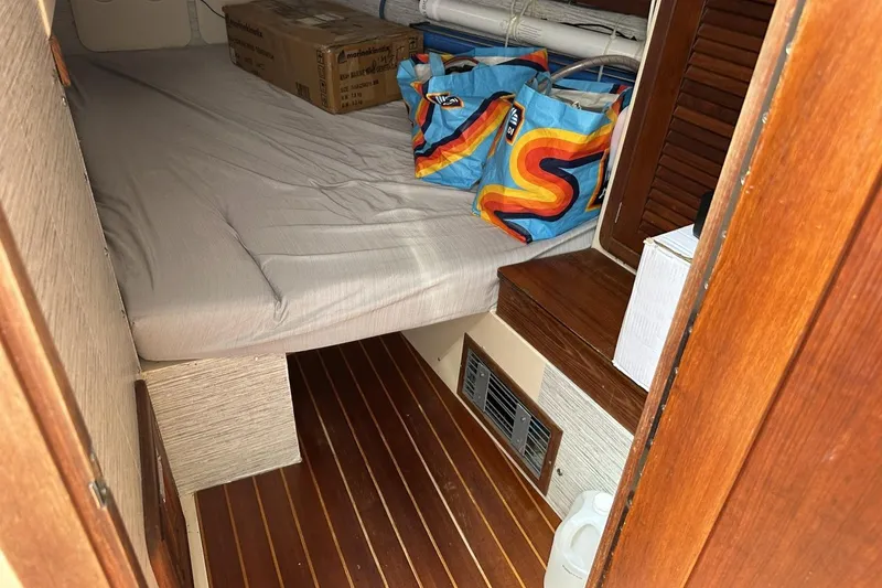 Slide: The Image of Cozy cabin interior of 1991 Catalina 42 sailboat with storage and bedding. - 74