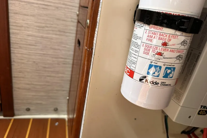 Slide: The Image of Fire extinguisher mounted on a 1991 Catalina 42 sailboat interior wall. - 77