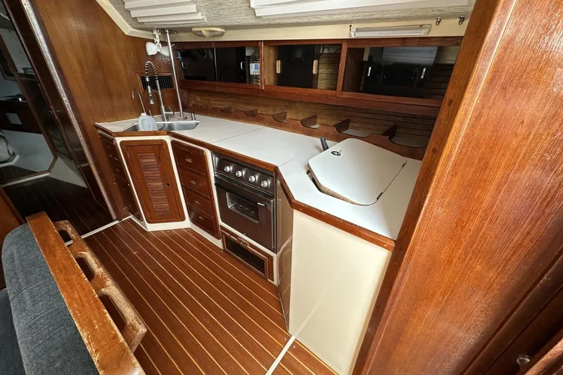 Slide: The Image of Interior of a 1991 Catalina 42 sailboat kitchen with wood cabinetry and stove. - 8