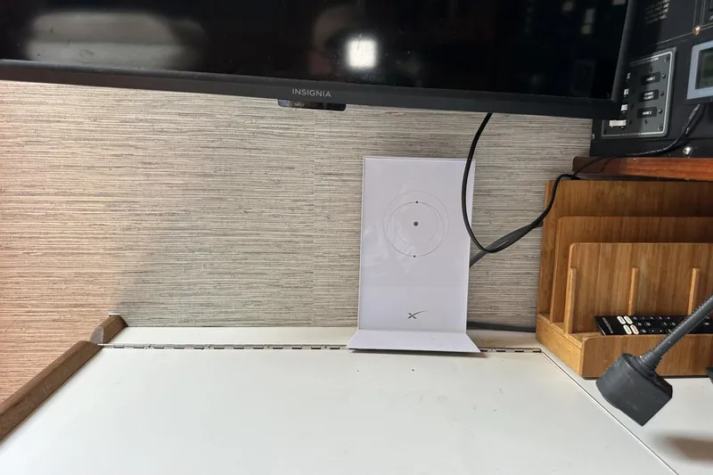 Slide: The Image of Workstation with Insignia monitor, wireless charger, and wooden organizer on Catalina 42 yacht. - 80