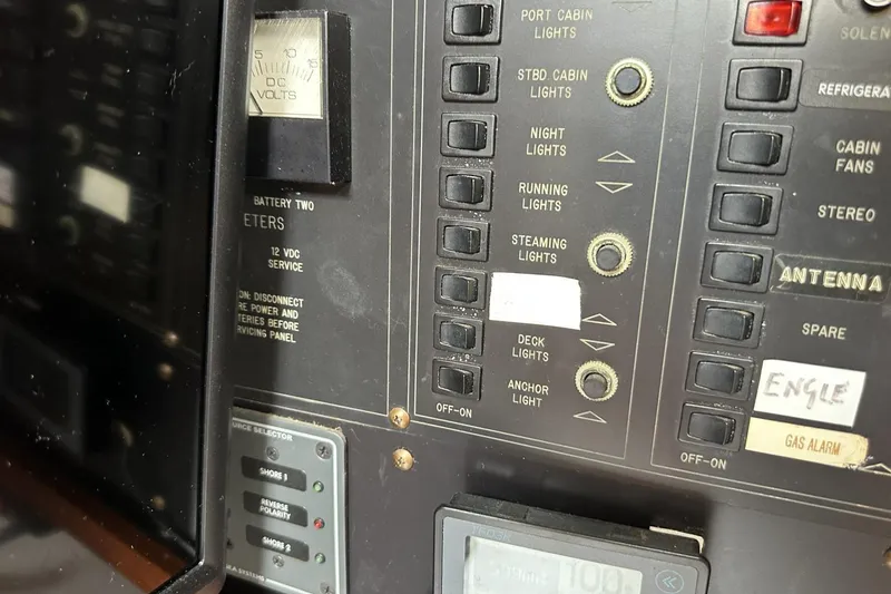 Slide: The Image of Control panel of a 1991 Catalina 42 sailboat with various switches and gauges. - 82