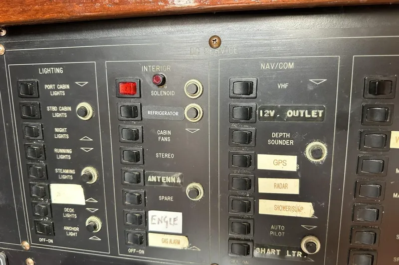 Slide: The Image of Control panel of a 1991 Catalina 42 sailboat with various switches and labels. - 83
