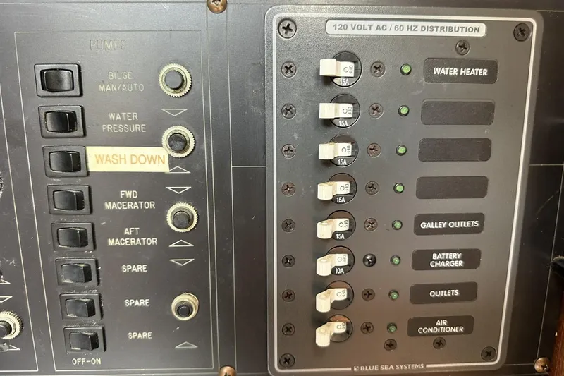 Slide: The Image of Electrical panel of a 1991 Catalina 42 boat with labeled switches and circuit breakers. - 84