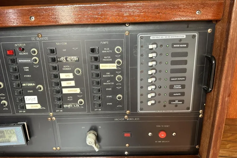 Slide: The Image of Control panel of a 1991 Catalina 42 sailboat with various switches and indicators. - 88