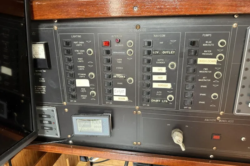 Slide: The Image of Control panel of a 1991 Catalina 42 sailboat with various switches and gauges. - 89