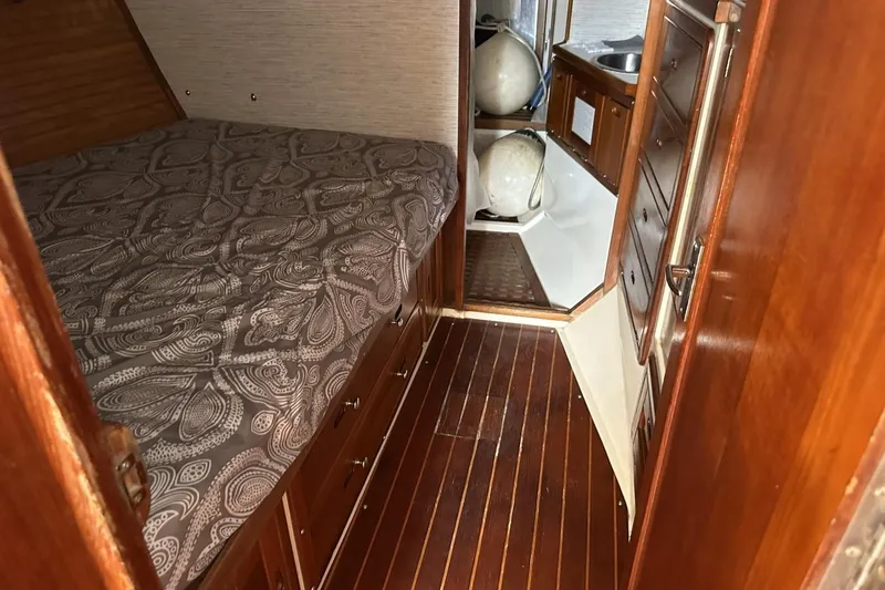 Slide: The Image of Interior of a 1991 Catalina 42 sailboat with wood paneling and cozy sleeping area. - 9