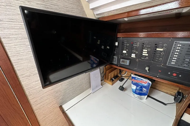 Slide: The Image of Control panel and monitor inside a 1991 Catalina 42 yacht cabin. - 90