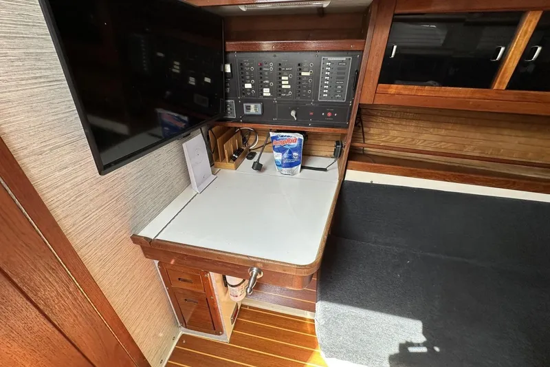 Slide: The Image of Navigation station of a 1991 Catalina 42 sailboat with control panel and desk. - 91