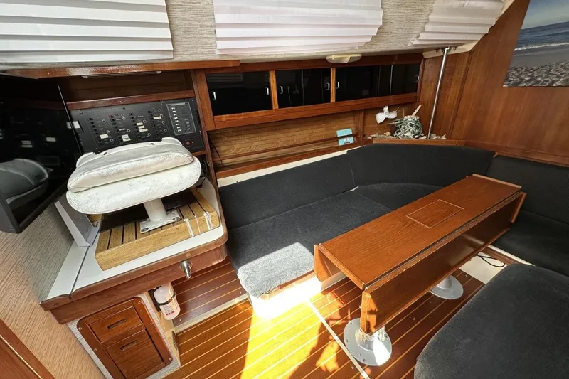 Slide: The Image of Interior of a 1991 Catalina 42 sailboat with wooden furnishings and seating area. - 92