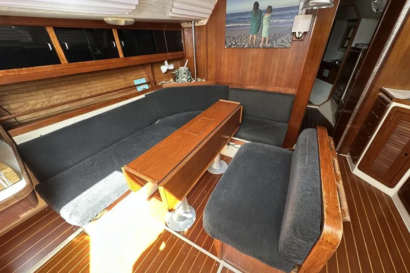 Slide: The Image of Interior of 1991 Catalina 42 sailboat with wooden furnishings and cozy seating area. - 93