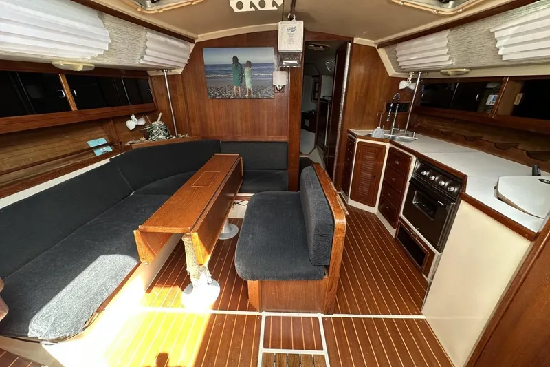 Slide: The Image of Interior of a 1991 Catalina 42 sailboat with wood finishes and cozy seating area. - 94