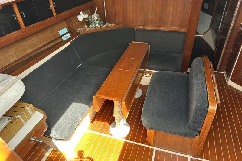 Slide: The Image of Interior of 1991 Catalina 42 sailboat with wooden table and cushioned seating. - 96