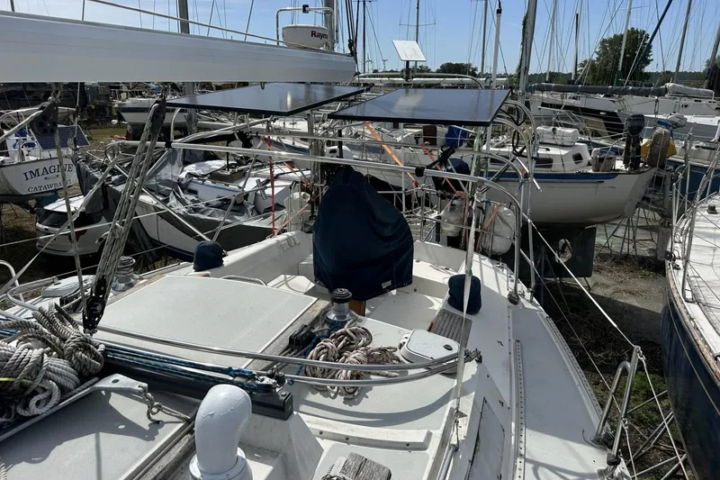 Slide: The Image of Sailboat Catalina 42, 1991 model, docked among other boats in a marina. - 97