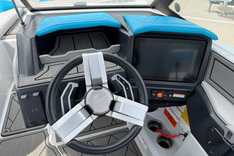 Slide: The Image of 2024 Tigé Z1 boat dashboard with modern steering wheel and touchscreen controls. - 14