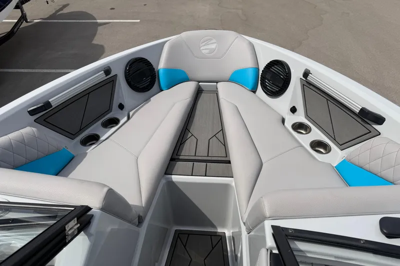 Slide: The Image of 2024 Tigé Z1 boat interior with gray and blue seating, cup holders, and speakers. - 5