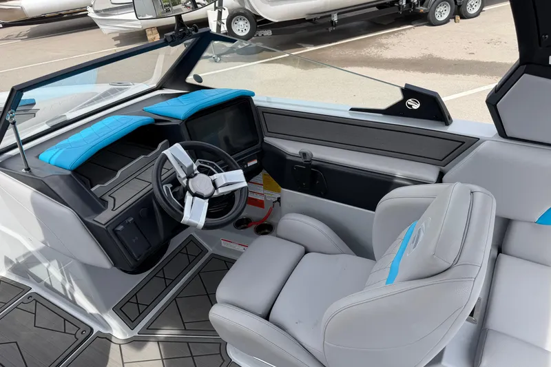 Slide: The Image of 2024 Tigé Z1 boat interior with modern steering and blue-accented seating. - 6