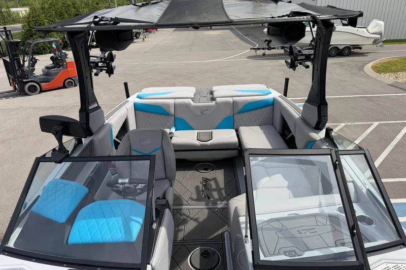 Slide: The Image of 2024 Tigé Z1 boat interior with blue and gray seating, open windshield, and modern design. - 8