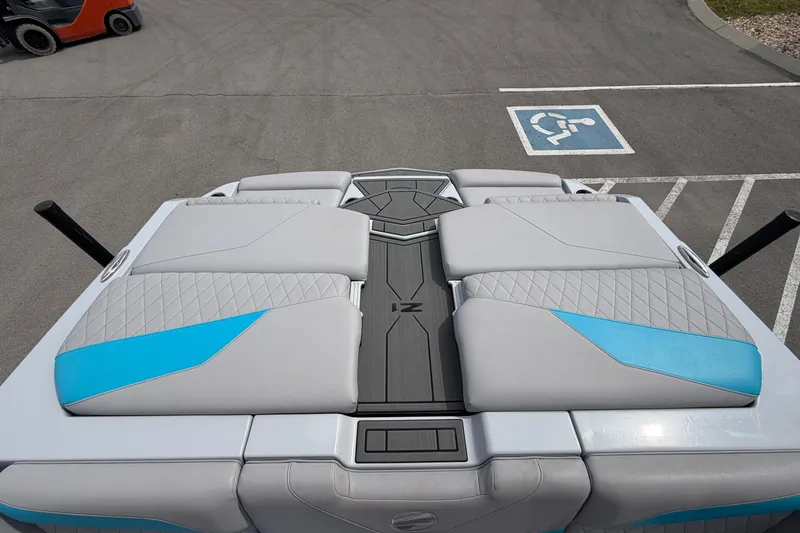 Slide: The Image of 2024 Tigé Z1 boat interior with gray and blue seating, parked near a handicap space. - 9