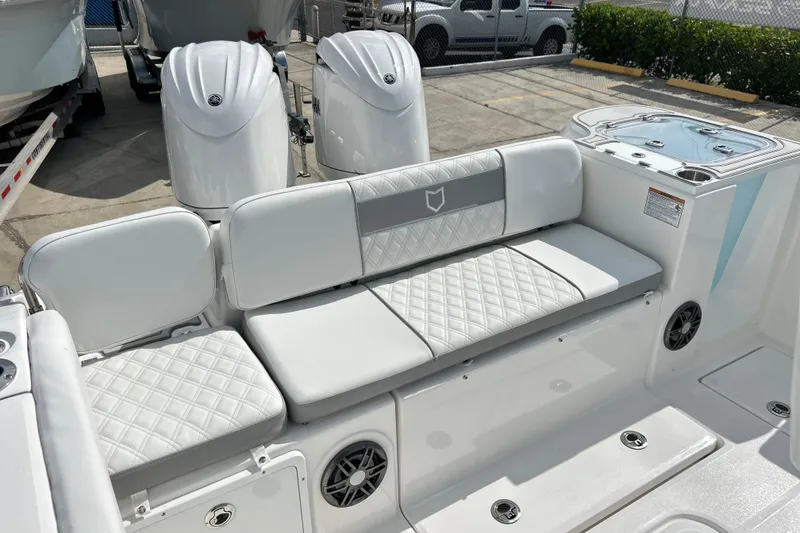 Slide: The Image of 2026 Sea Fox 268 Commander boat interior with cushioned seating and dual engines. - 16