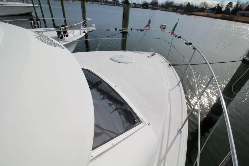 Slide: The Image of 1997 Cruisers Yachts 3650 Motoryacht docked, featuring sleek white deck and railings. - 9