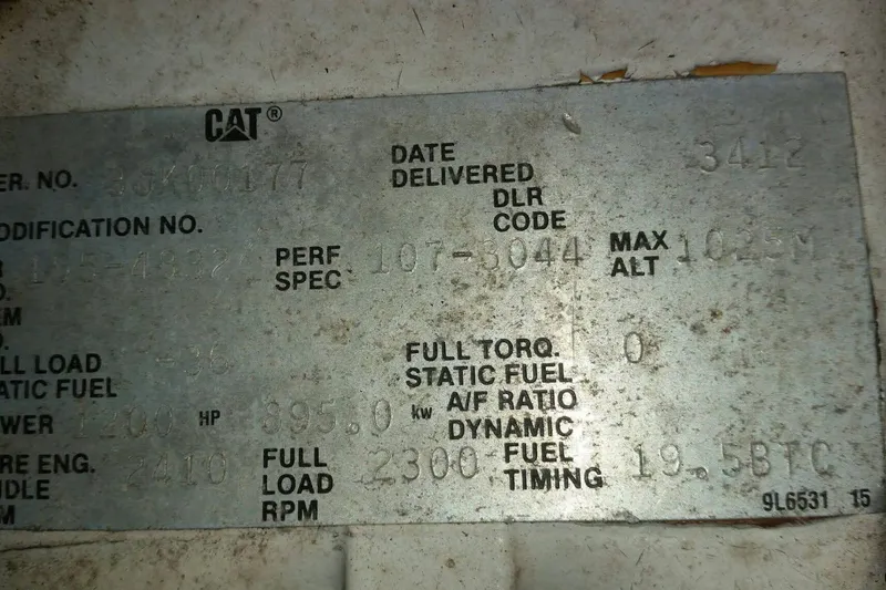 Slide: The Image of Metallic CAT engine specification plate with performance details for a 1994 Breaux Bay Craft 58 Sportfish. - 12